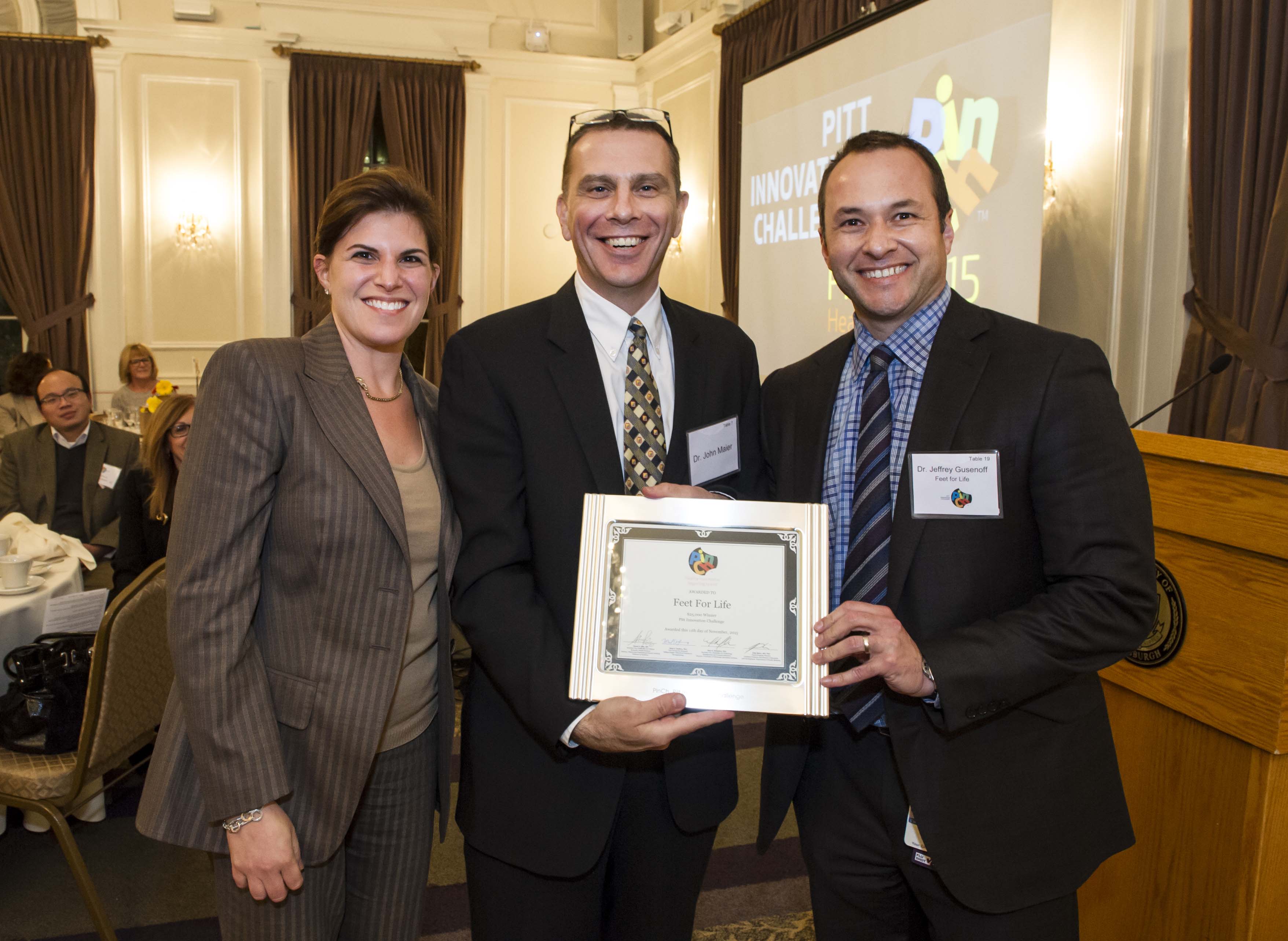 Feet for Life team holding award