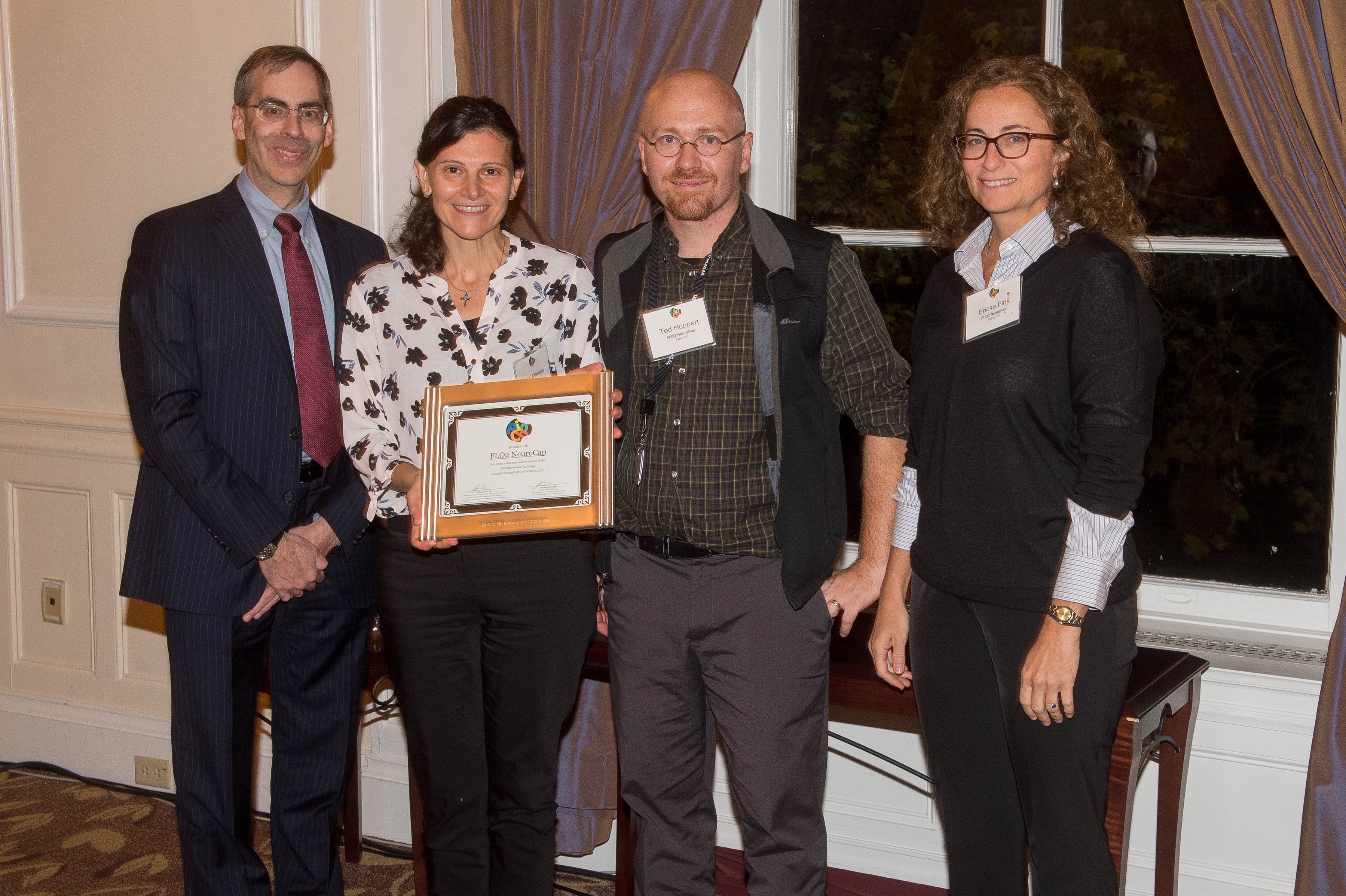 FLO2 NeuroCap team holding award